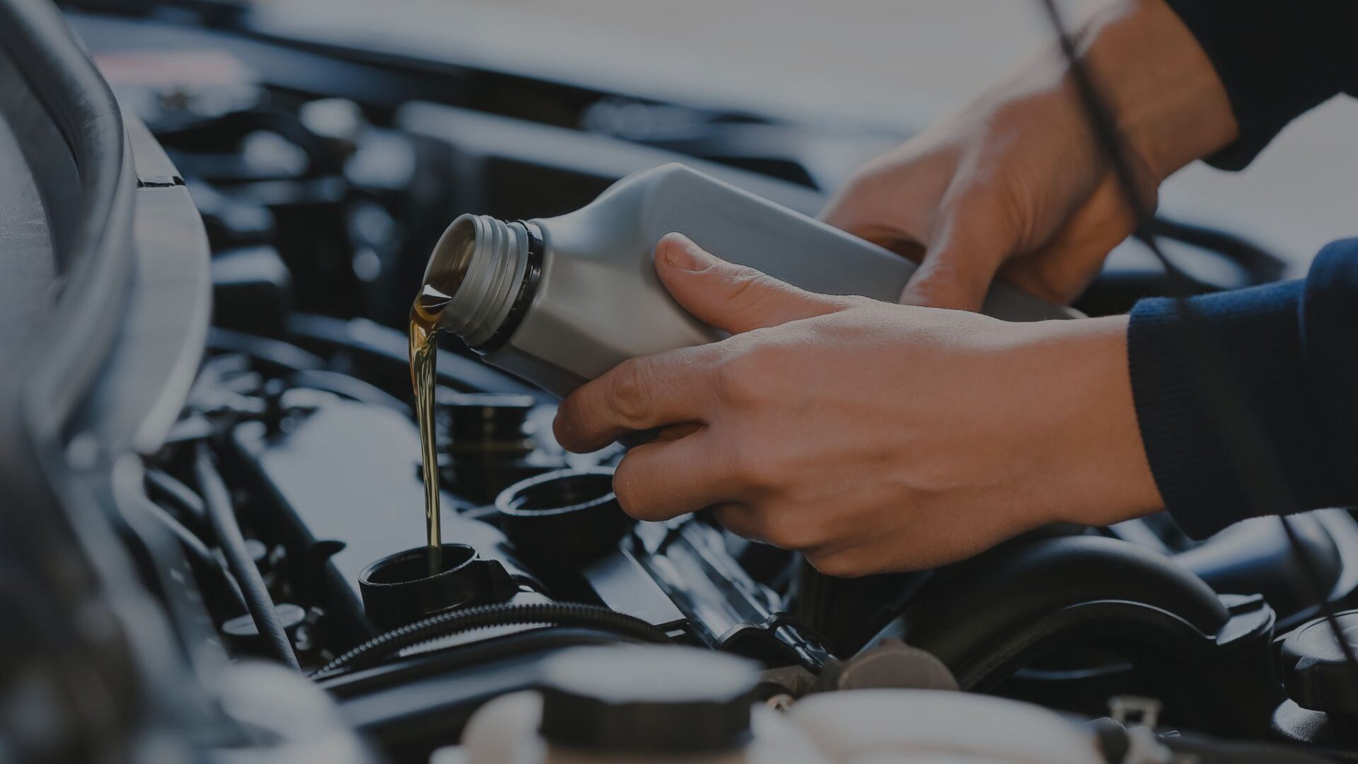 A photo with a background of a mechanic changing the car oil.